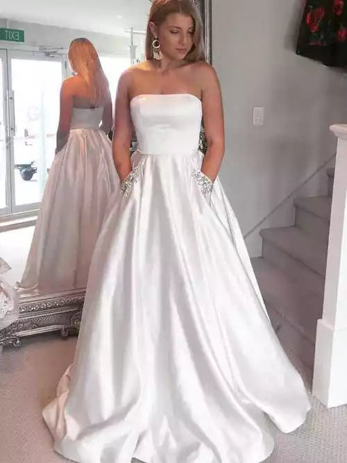 Elegant Ivory Satin Ballgown with Strapless Neckline & Embellished Pockets