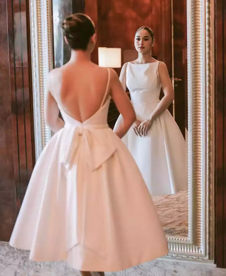 Elegant Ivory Satin Tea-Length Gown with Open Back & Bow Detail
