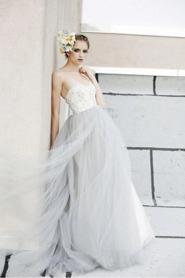 Ethereal strapless tulle wedding dress with beaded lace bodice and voluminous skirt