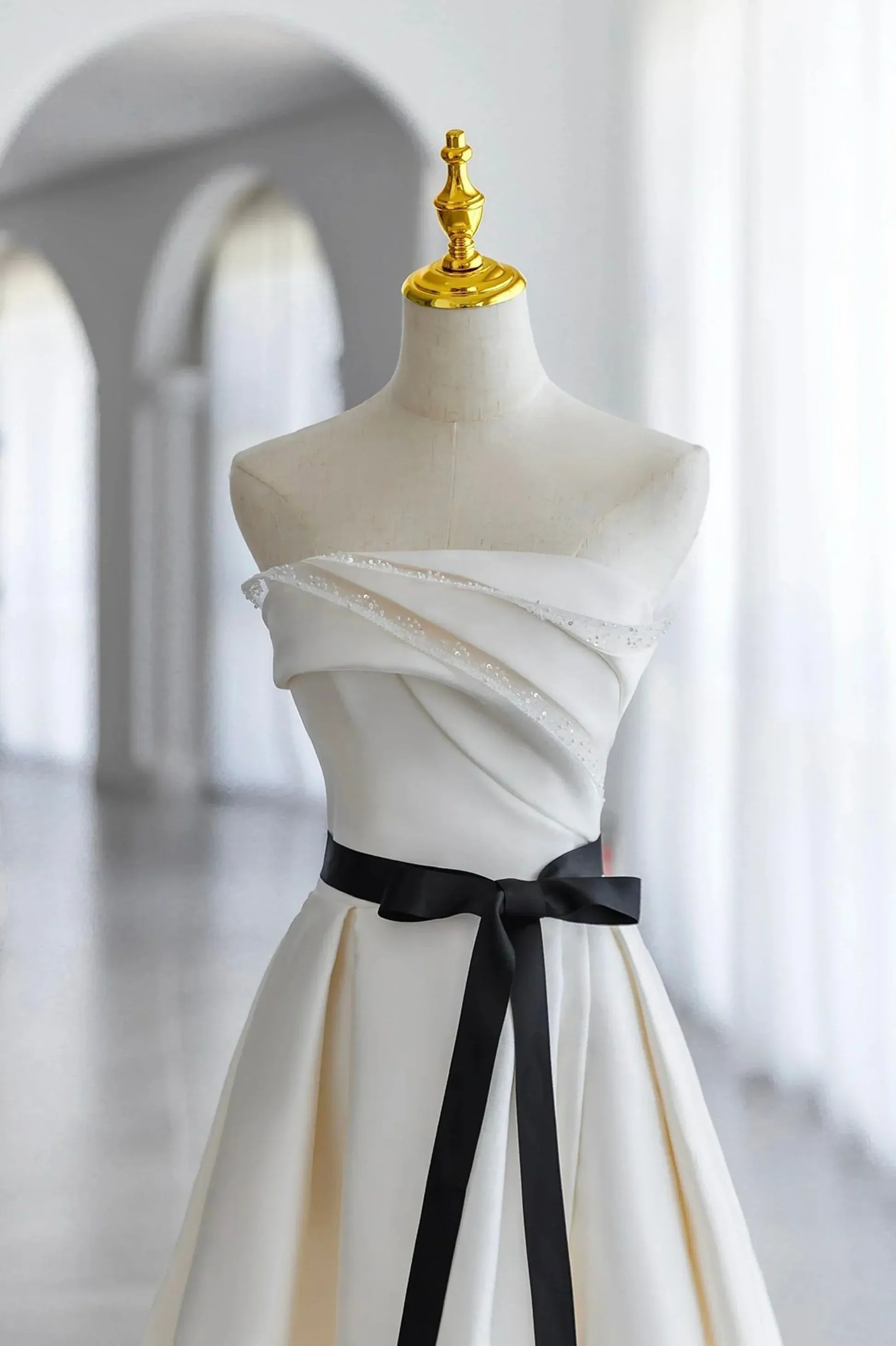 Ivory Off-the-Shoulder Satin A-Line Wedding Dress with Black Sash and Lace-Up Back