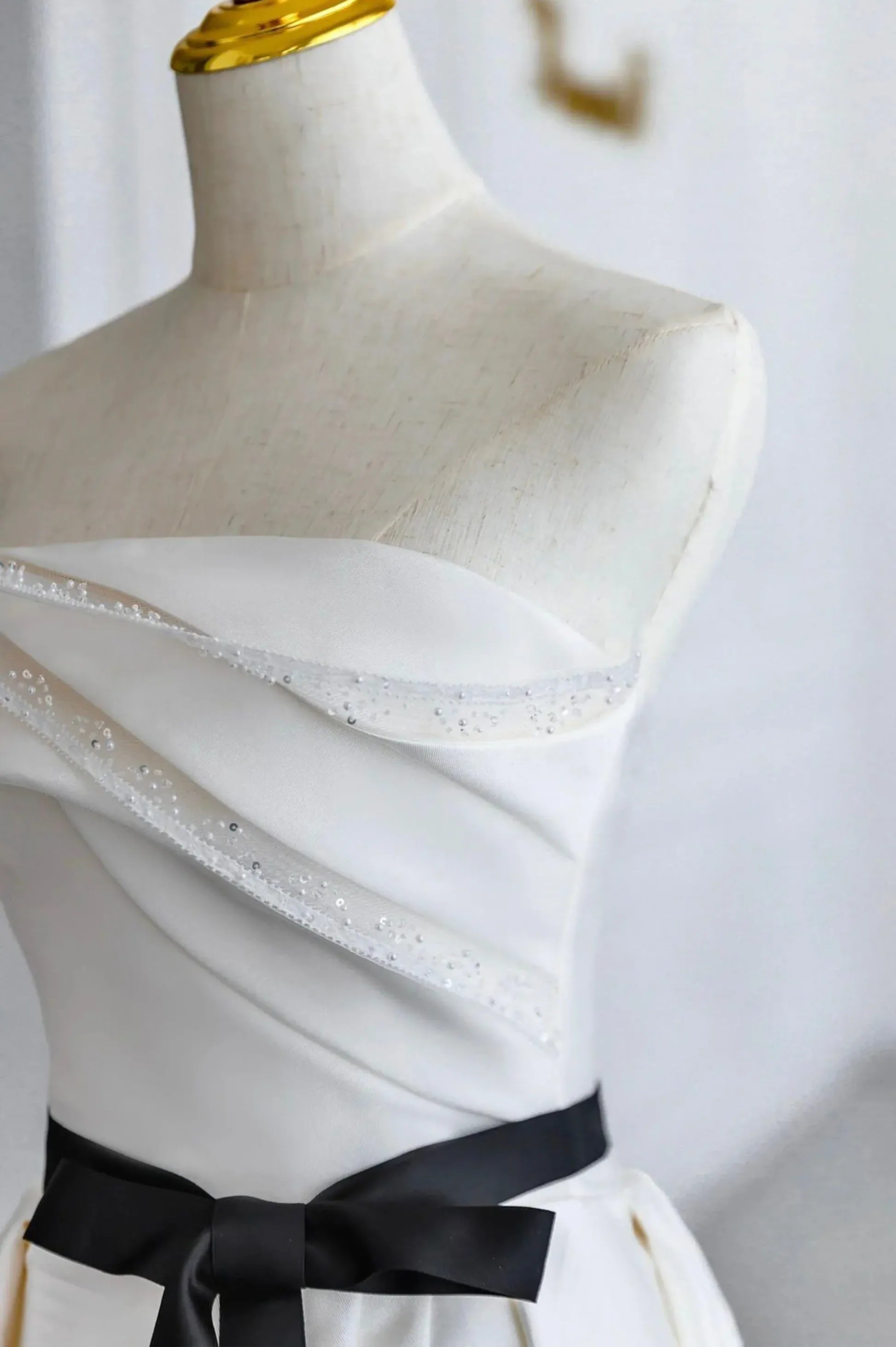 Ivory Off-the-Shoulder Satin A-Line Wedding Dress with Black Sash and Lace-Up Back