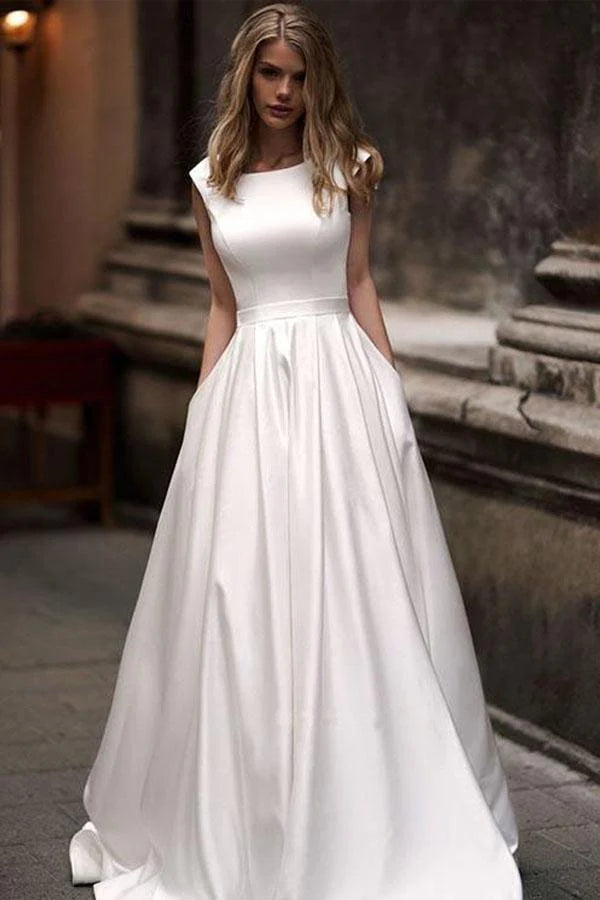 Minimalist satin ball gown wedding dress with cap sleeves, deep V-back and side pockets