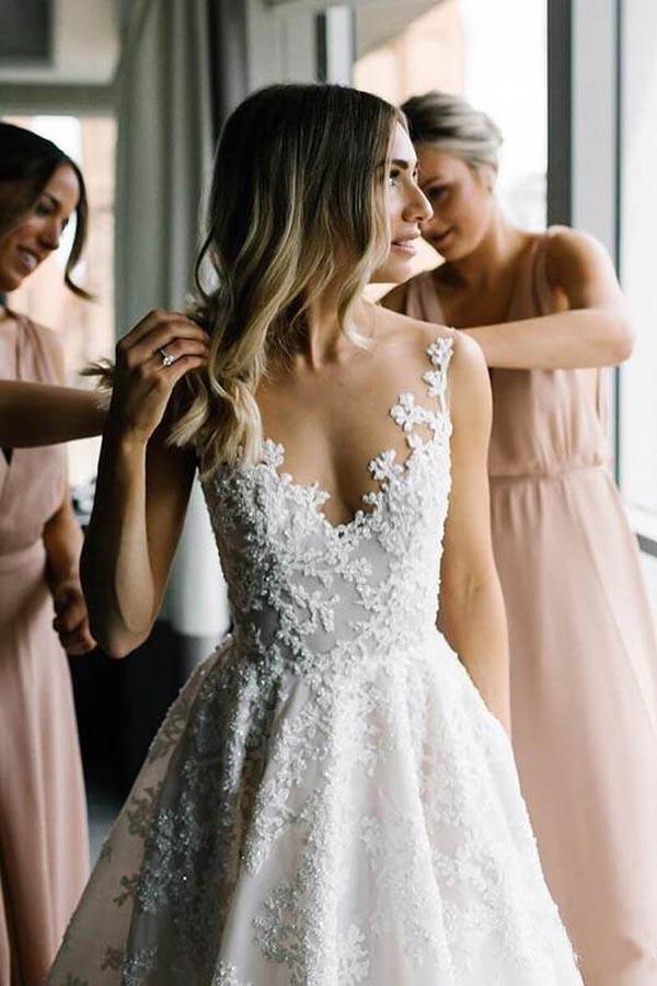 Romantic A-line wedding dress with illusion straps, beaded lace appliqué and chapel train