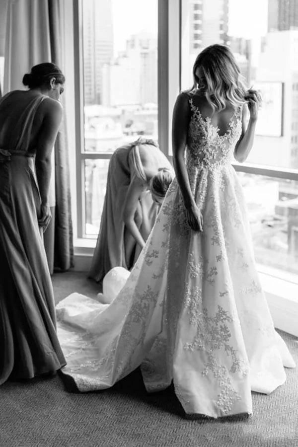 Romantic A-line wedding dress with illusion straps, beaded lace appliqué and chapel train