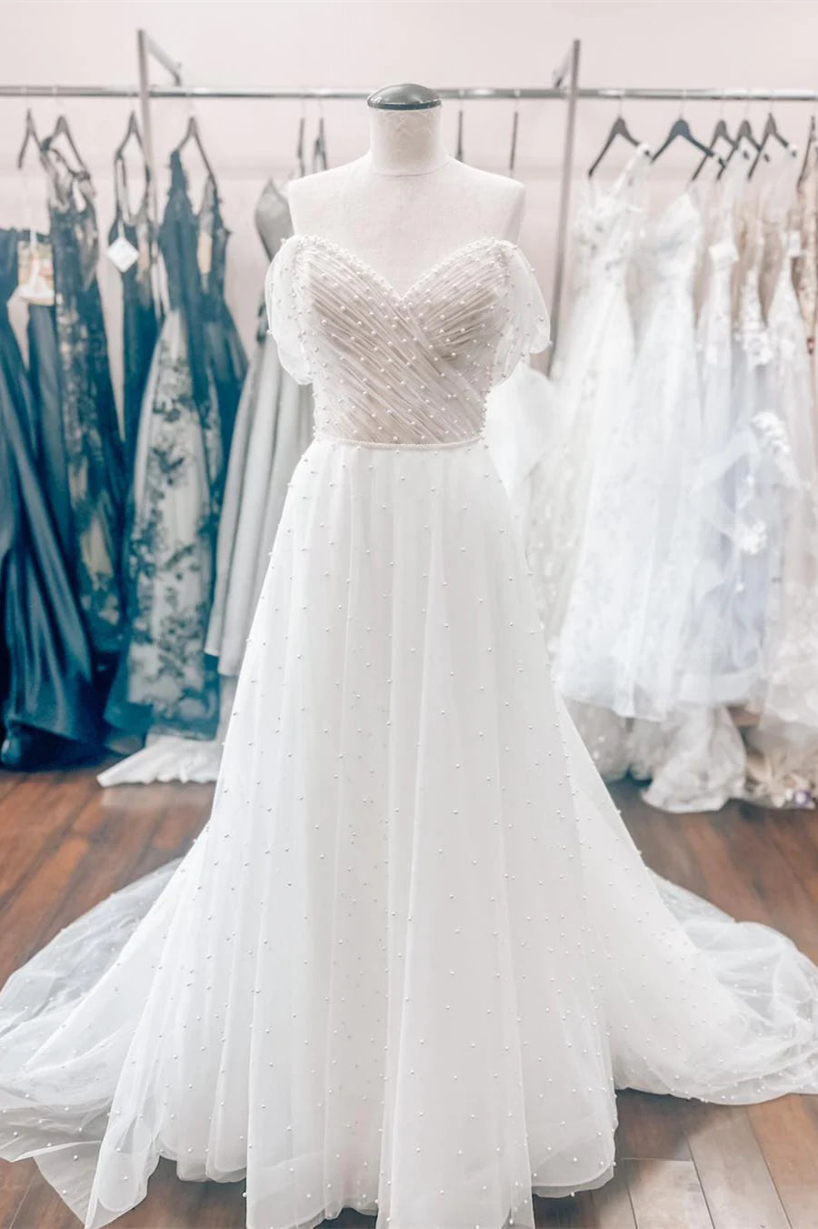 White Off-the-Shoulder Wedding Dress with Pearl Embellishments and Tulle Train