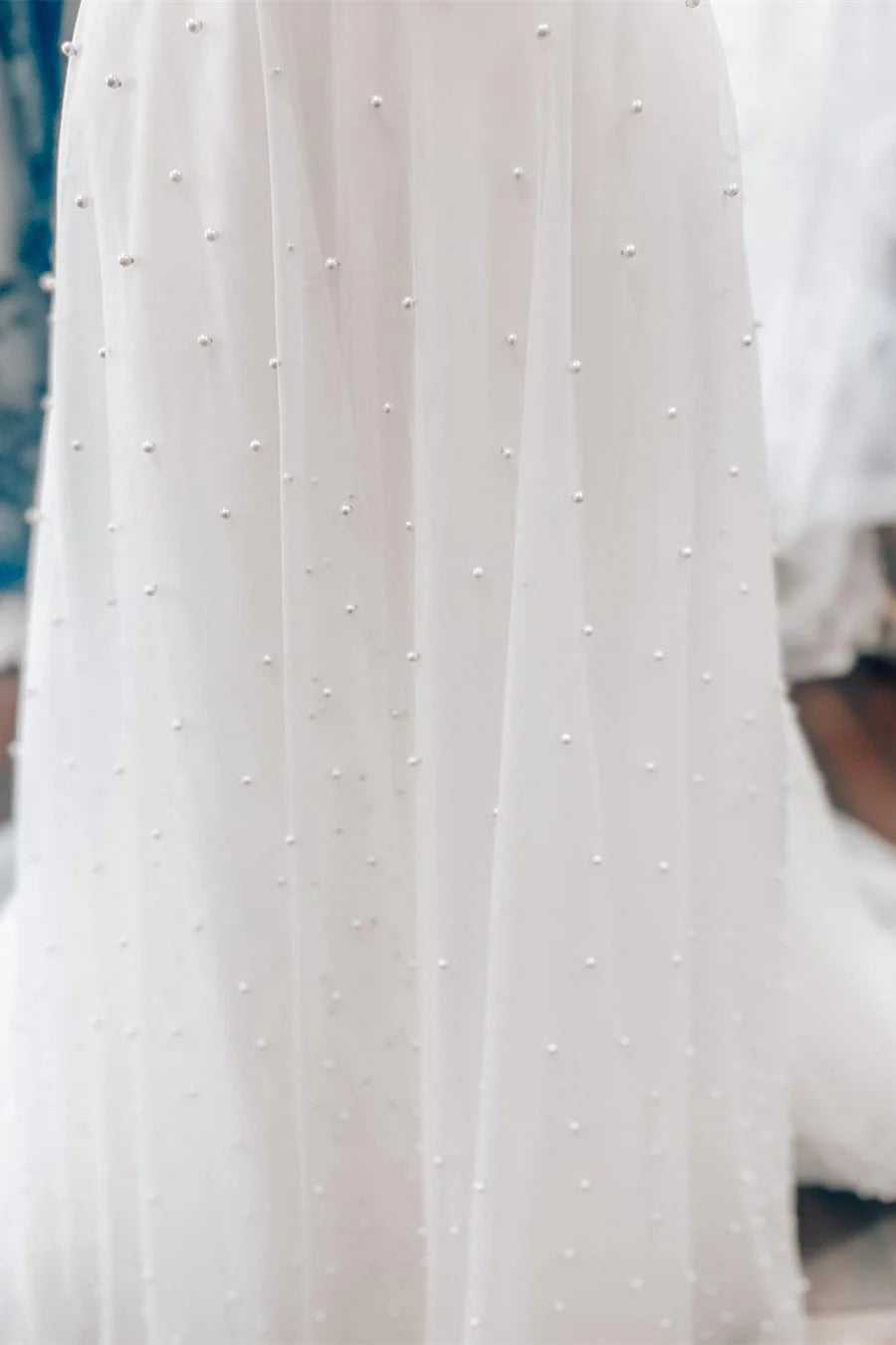 White Off-the-Shoulder Wedding Dress with Pearl Embellishments and Tulle Train