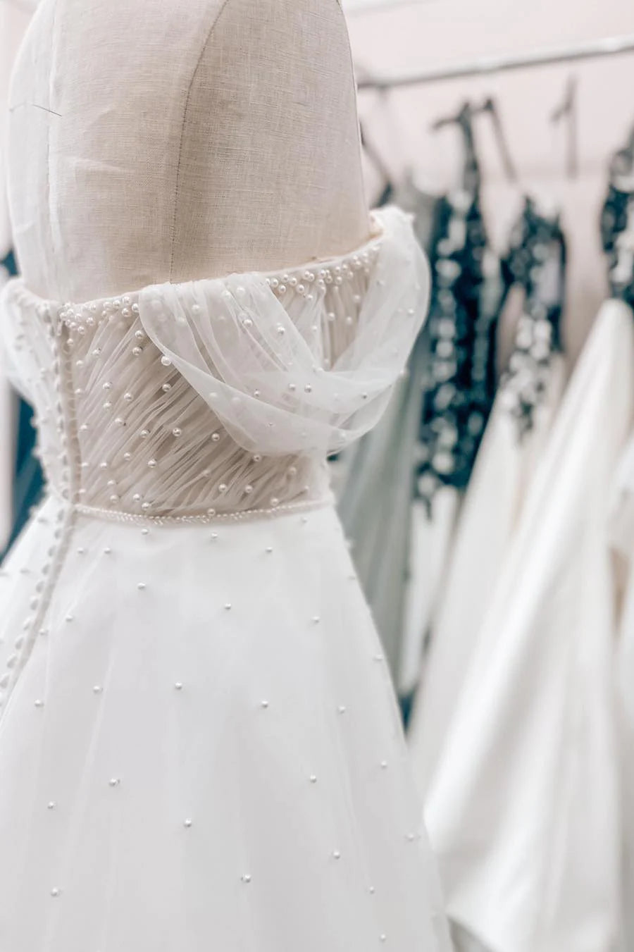 White Off-the-Shoulder Wedding Dress with Pearl Embellishments and Tulle Train