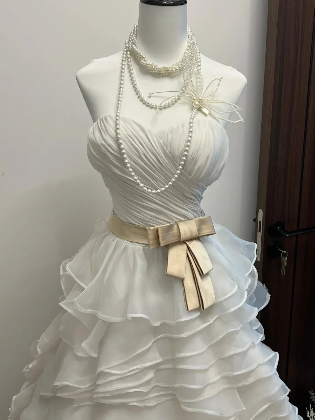 White Strapless Sweetheart Neckline Ruffled Tulle Gown with Champagne Satin Bow